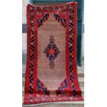 A Persian rug, 20th century, the rectangular cafe au lait coloured ground centred with a blue floral