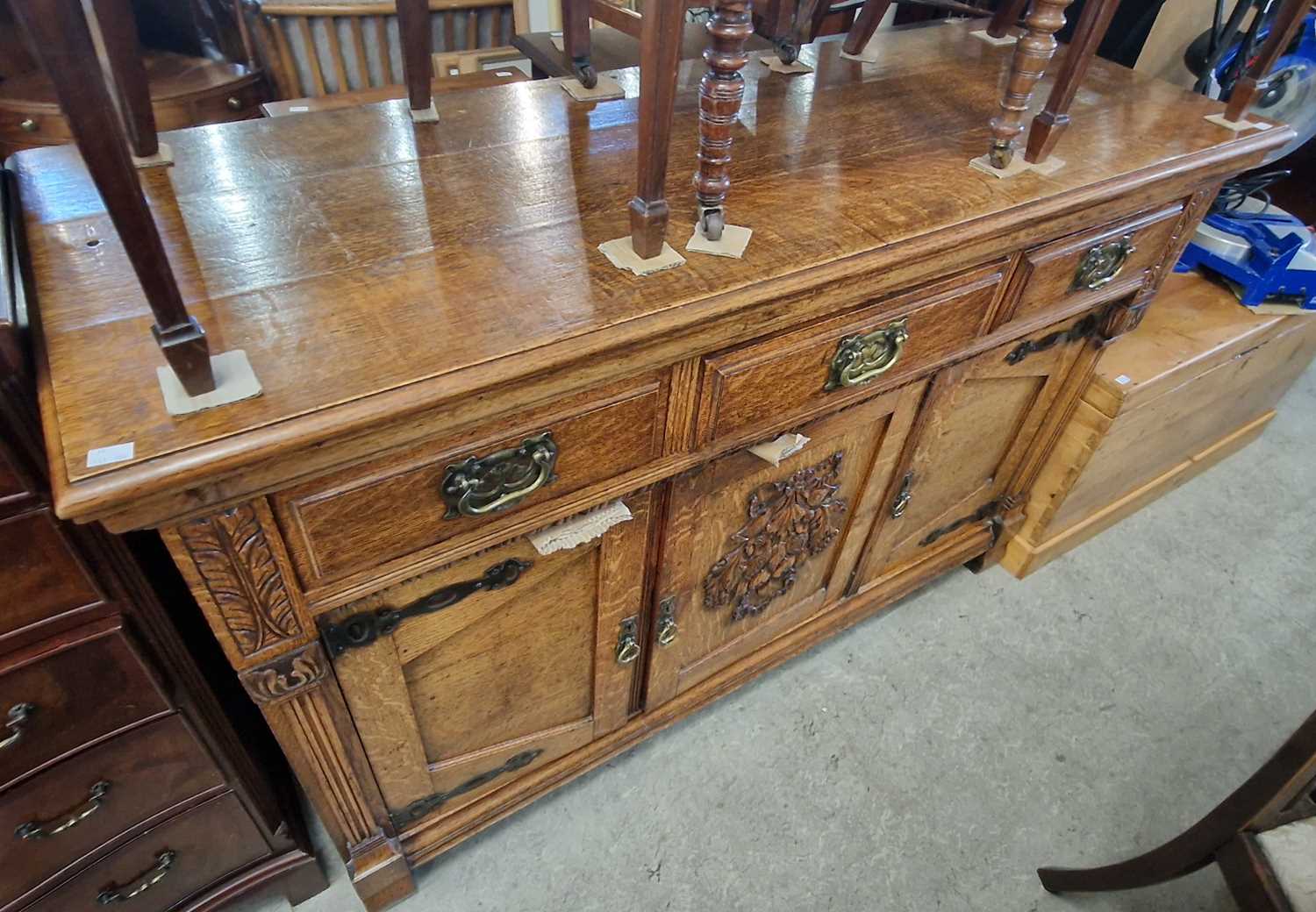 A Victorian oak sideboard fitted with three frieze drawers and three cupboard doors below, 152.5cm