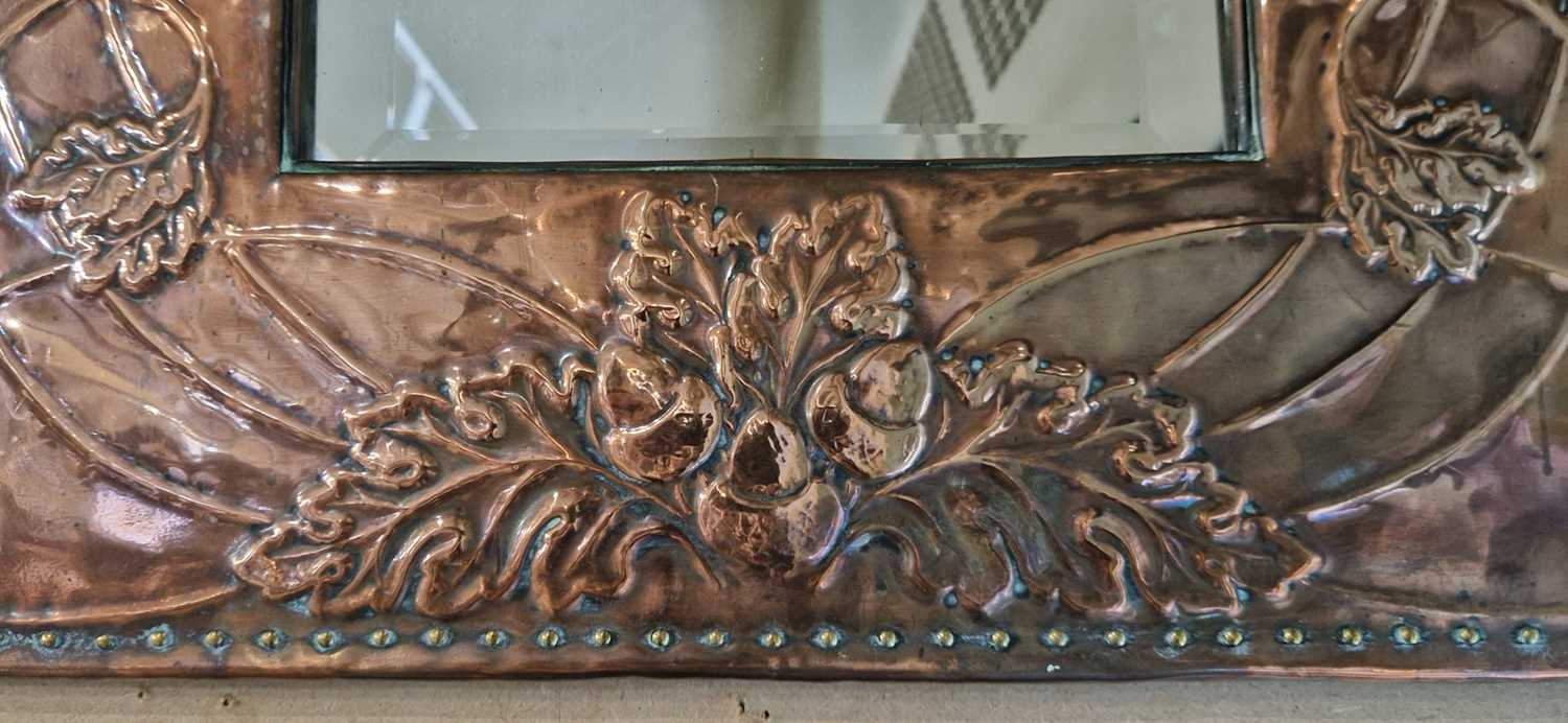 An early 20th century Arts & Crafts copper wall mirror, the frame embossed with acorns and - Bild 2 aus 2