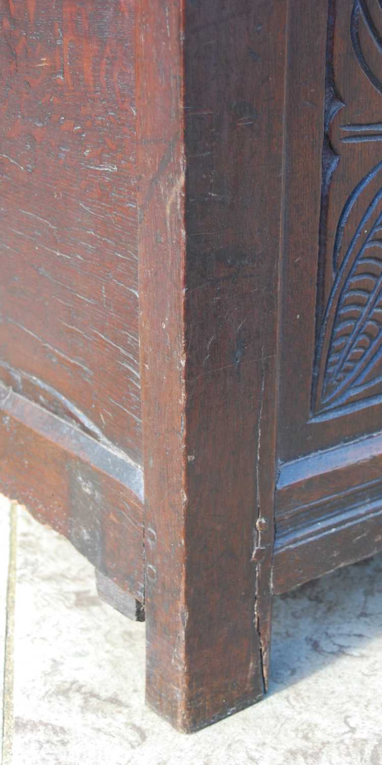 A George III oak coffer, the triple panel hinged cover over a triple panel front carved with three - Image 3 of 7