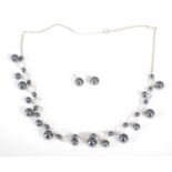 A silver and pearl necklace together with a matching pair of earrings, necklace 45cm long, gross