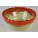 A Strathearn glass bowl mottled orange and yellow with band of typical whorls, 24.5cm diameter x