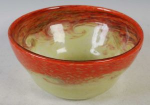 A Strathearn glass bowl mottled orange and yellow with band of typical whorls, 24.5cm diameter x
