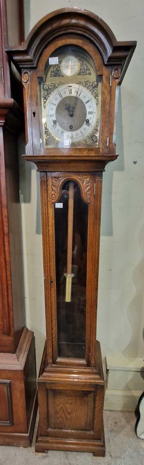 A vintage oak grandmother clock, brass dial and silvered chapter ring with chime silent feature,