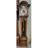 A vintage oak grandmother clock, brass dial and silvered chapter ring with chime silent feature,