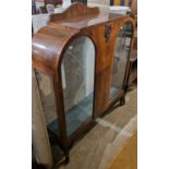 An early 20th century walnut display cabinet in the Art Deco style, with two glazed cupboard doors