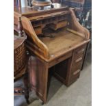 A vintage oak roll-top desk with serpentine tambour front, the lock plate inscribed 'Angus', 83cm