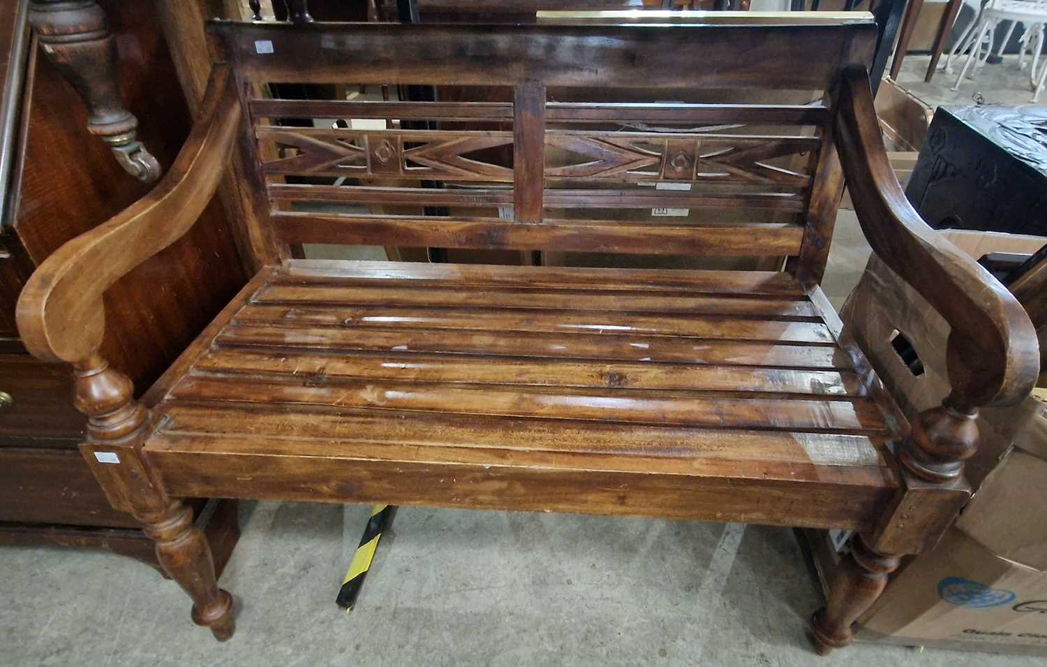 A stained wood hall bench with slatted back and seat on turned supports, 100cm wide.
