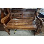 A stained wood hall bench with slatted back and seat on turned supports, 100cm wide.
