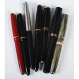 A collection of vintage fountain pens to include a Parker Slimfold with 14k nib together with four