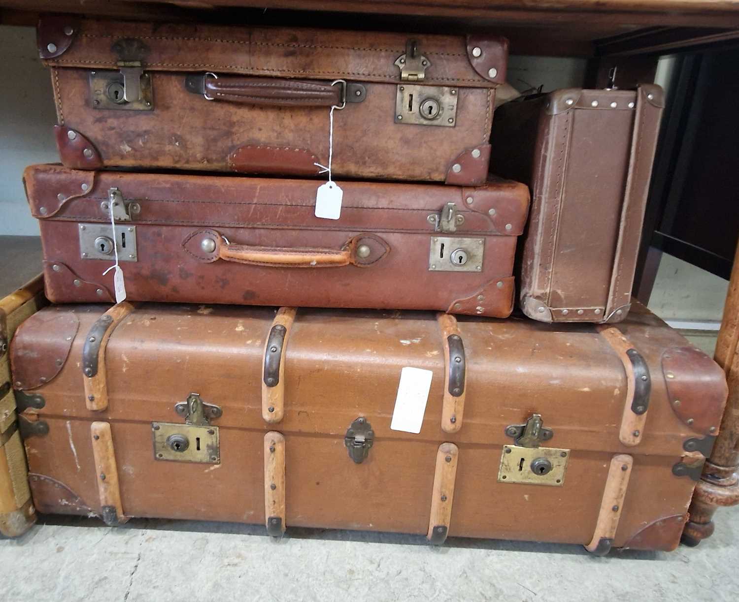 A vintage leather suitcase bearing initials 'I.H.', together with two other various suitcases and