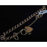 A 9ct gold bracelet with heart-shaped lock, gross weight 10.8 grams.