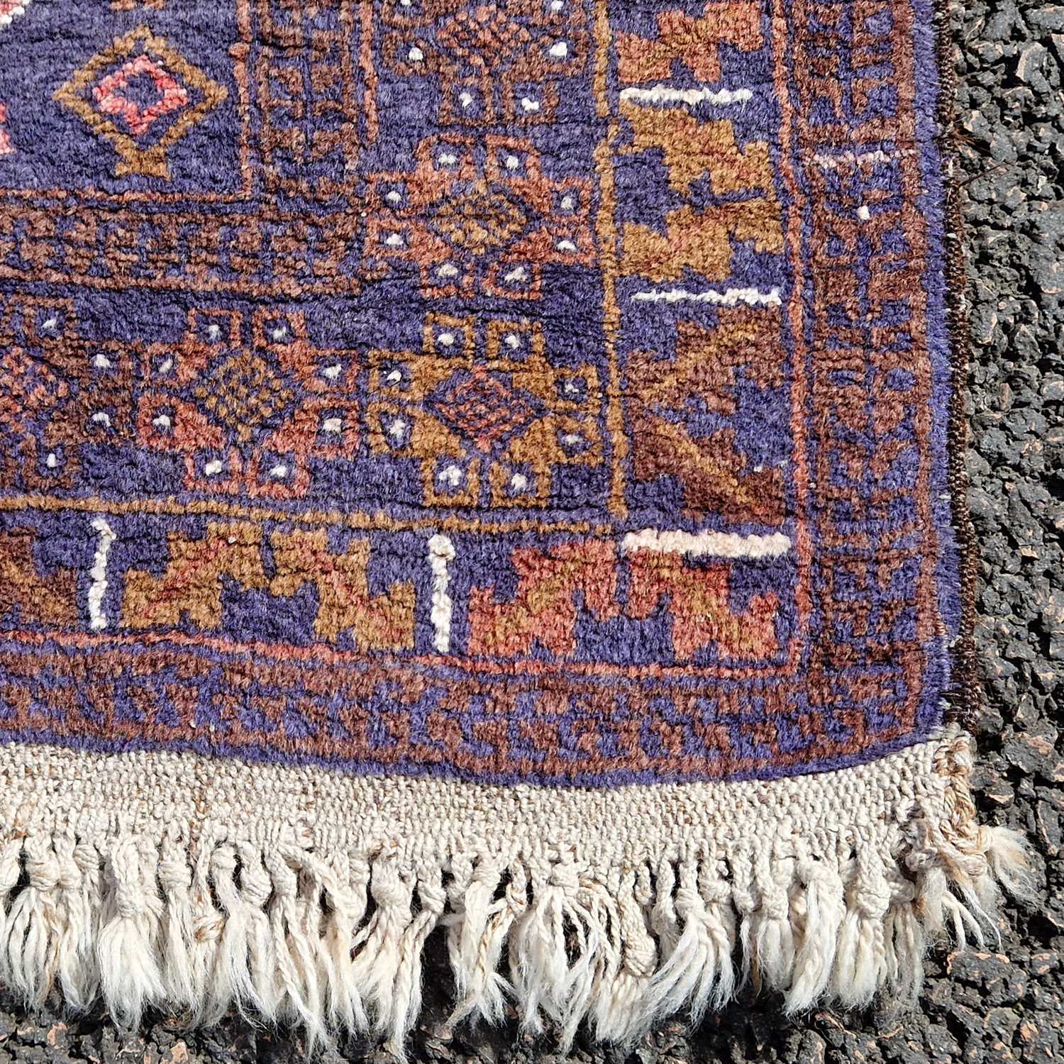 A Persian rug, 20th century, the blue ground decorated in white madder and ochre coloured threads - Image 3 of 4