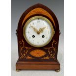 An Edwardian inlaid mahogany mantle clock of gothic arched form, with shaped brass carry handles and