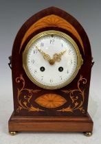 An Edwardian inlaid mahogany mantle clock of gothic arched form, with shaped brass carry handles and