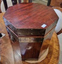 A 20th century mahogany and brass bound octagonal shaped celarette with lion mask and ring