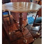 A 19th century walnut and parquetry inlaid pedestal games table, the shaped oval top centred with