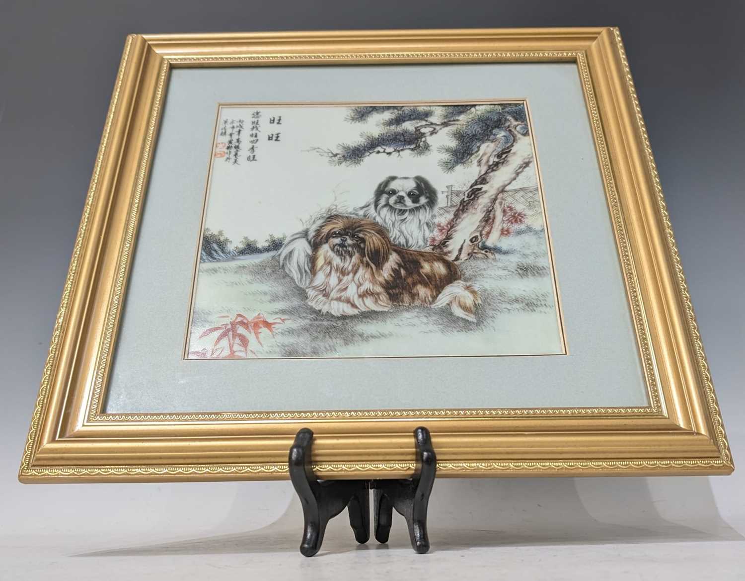 A late 20th Century Chinese painted porcelain square plaque by AiQin Cao (B. 1954), of two Pekingese