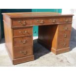 A late 19th century oak pedestal desk, the rectangular top with a moulded edge over a central frieze