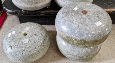Three granite curling stones (lacking handles).