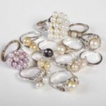 Twelve silver and white metal pearl set dress rings.