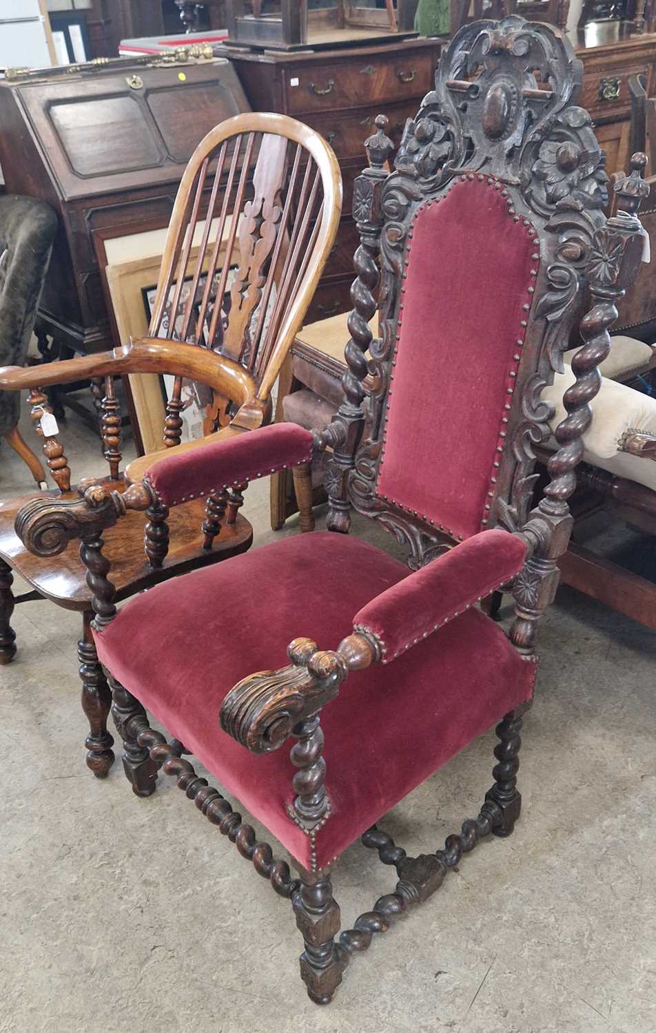 An antique stained oak throne / hall chair, in the Jacobean style with claret coloured velvet