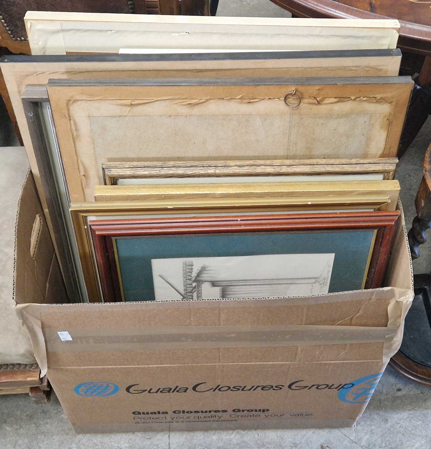 A box of assorted decorative pictures and prints.