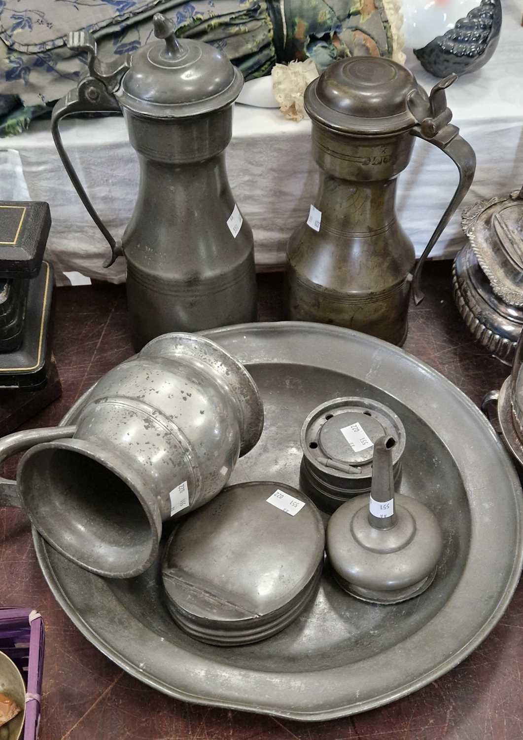 A collection of antique pewter ware, items to include two lidded tappit hens, a tankard, an inkwell,