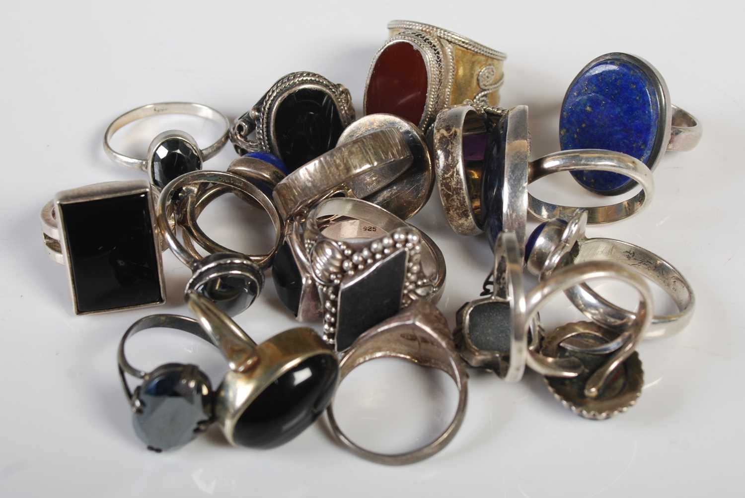 A collection of fifteen assorted silver and white metal dress rings.