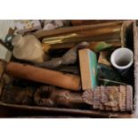 A box of assorted mixed wares to include a brass shell casing, carved wooden figure, spelter