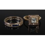 An early 20th century blue and white sapphire set white metal eternity ring, stamped 9CT, ring