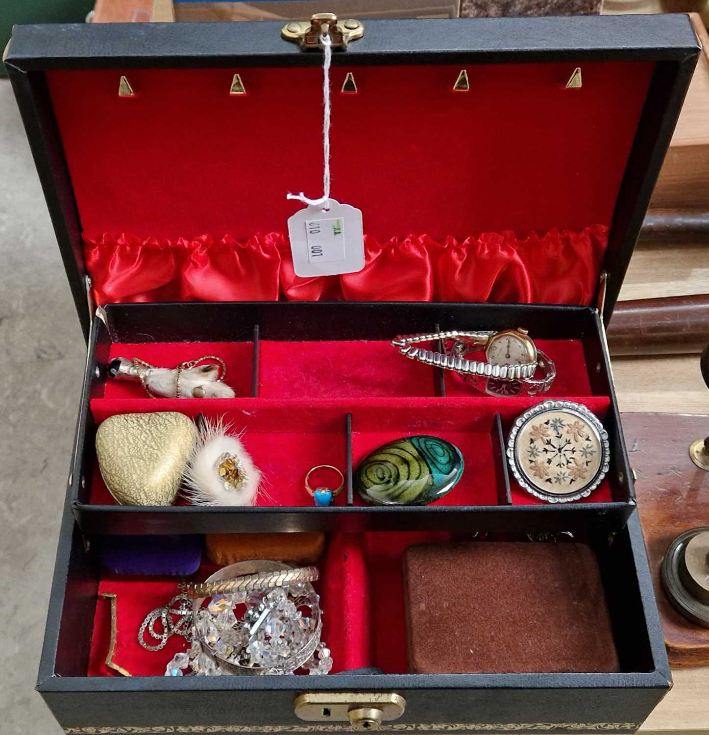 A vintage jewellery box containing assorted costume jewellery to include, a yellow metal bracelet