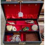 A vintage jewellery box containing assorted costume jewellery to include, a yellow metal bracelet