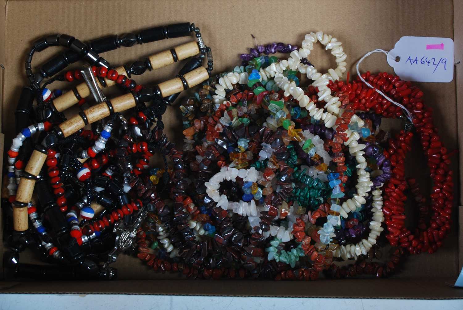 A box of assorted costume jewellery to include triple strand coral necklace, assorted stone and