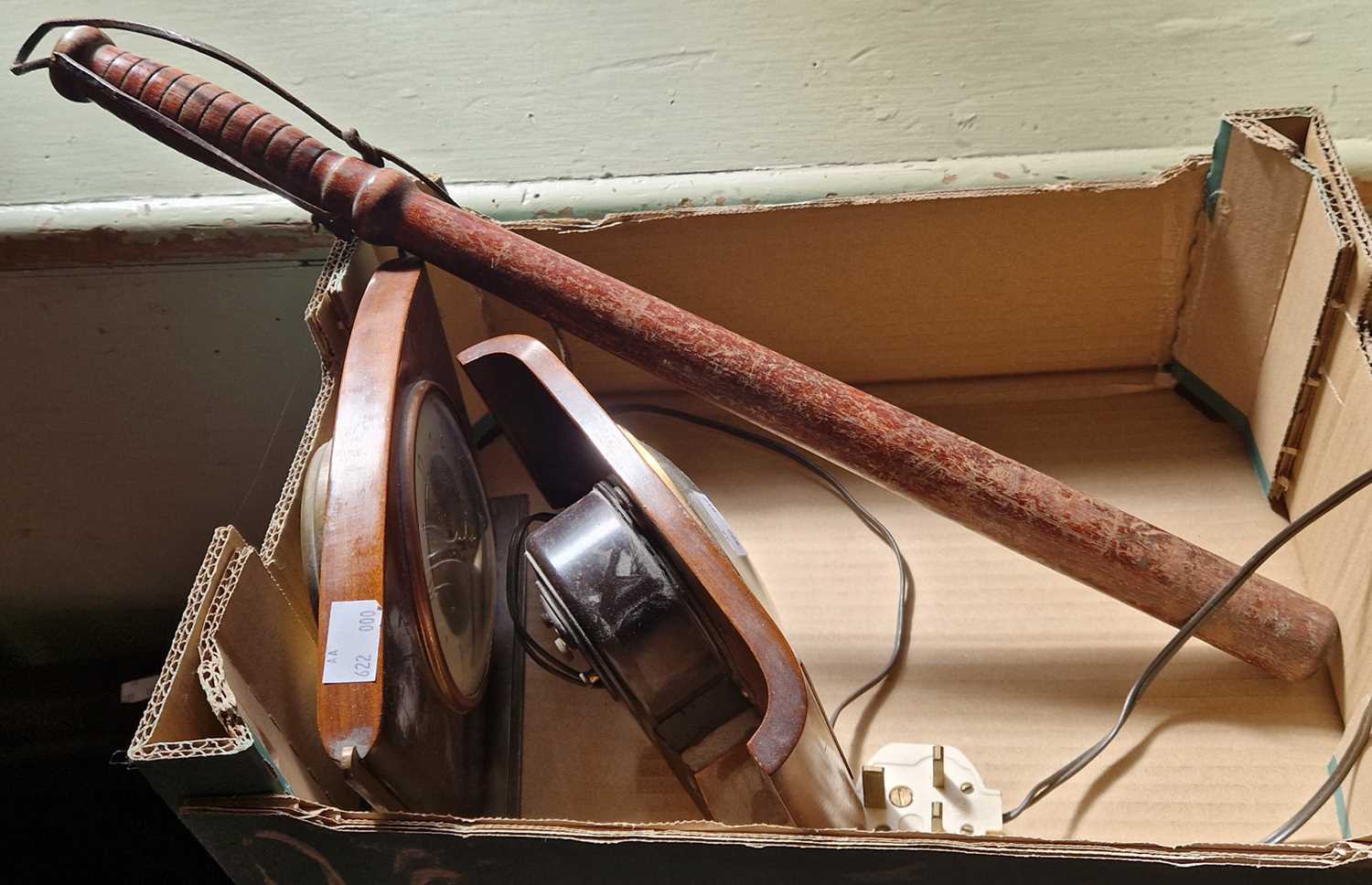 A vintage wooden baton and two mantle clocks.