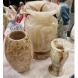 Three stone vases, to include a vase with fossil inclusions, and two assorted onyx hard stone
