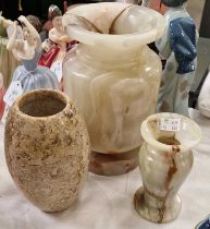 Three stone vases, to include a vase with fossil inclusions, and two assorted onyx hard stone