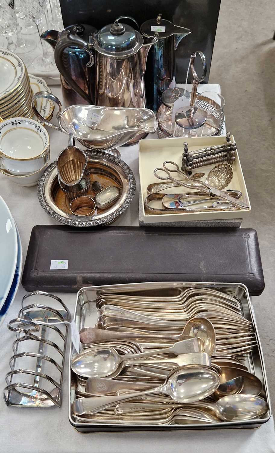 A collection of EPNS wares to include assorted flatware with various monograms, toast rack, bottle