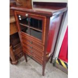 An Edwardian mahogany and satinwood banded side cabinet with glazed fall-front over four shallow