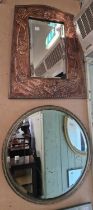 An early 20th century Arts & Crafts copper wall mirror, the frame embossed with acorns and
