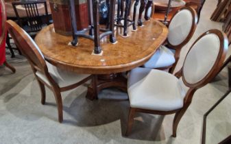 A John Lewis burr walnut extending pedestal dining table and four upholstered dining chairs.