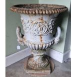 A late 19th century cast iron garden urn, of Campana form, decorated in relief with scrolling
