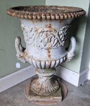 A late 19th century cast iron garden urn, of Campana form, decorated in relief with scrolling