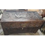 A Chinese camphor wood blanket box, carved in relief with figures and pine trees, 104cm wide.