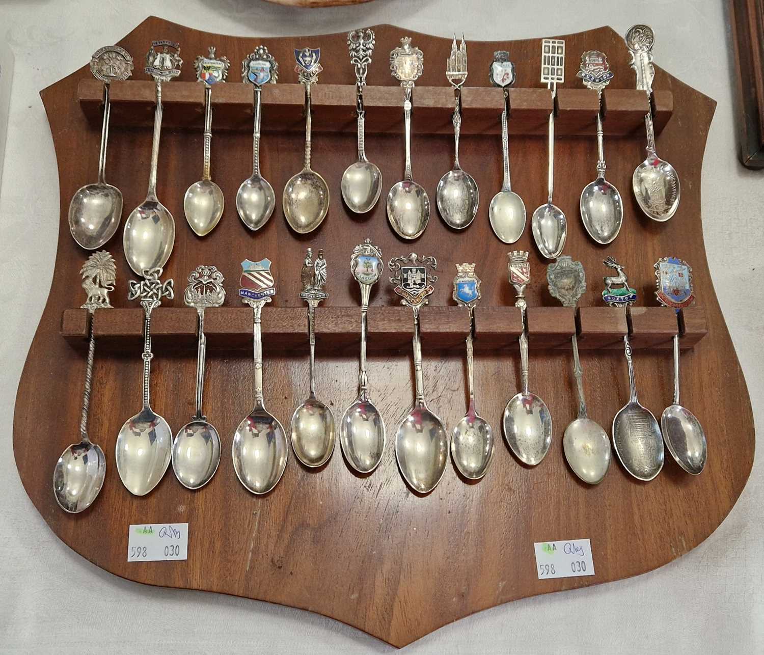 A collection of mixed Silver and EPNS Souvenir teaspoons, with various towns and crests mounted on a