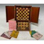 An early 20th Century mahogany compact folding chess set (complete), together with a wooden slide