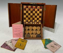 An early 20th Century mahogany compact folding chess set (complete), together with a wooden slide