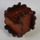 A mahogany puzzle money bank inscribed ‘Edward Tuer’, 14cm high x 14cm wide.