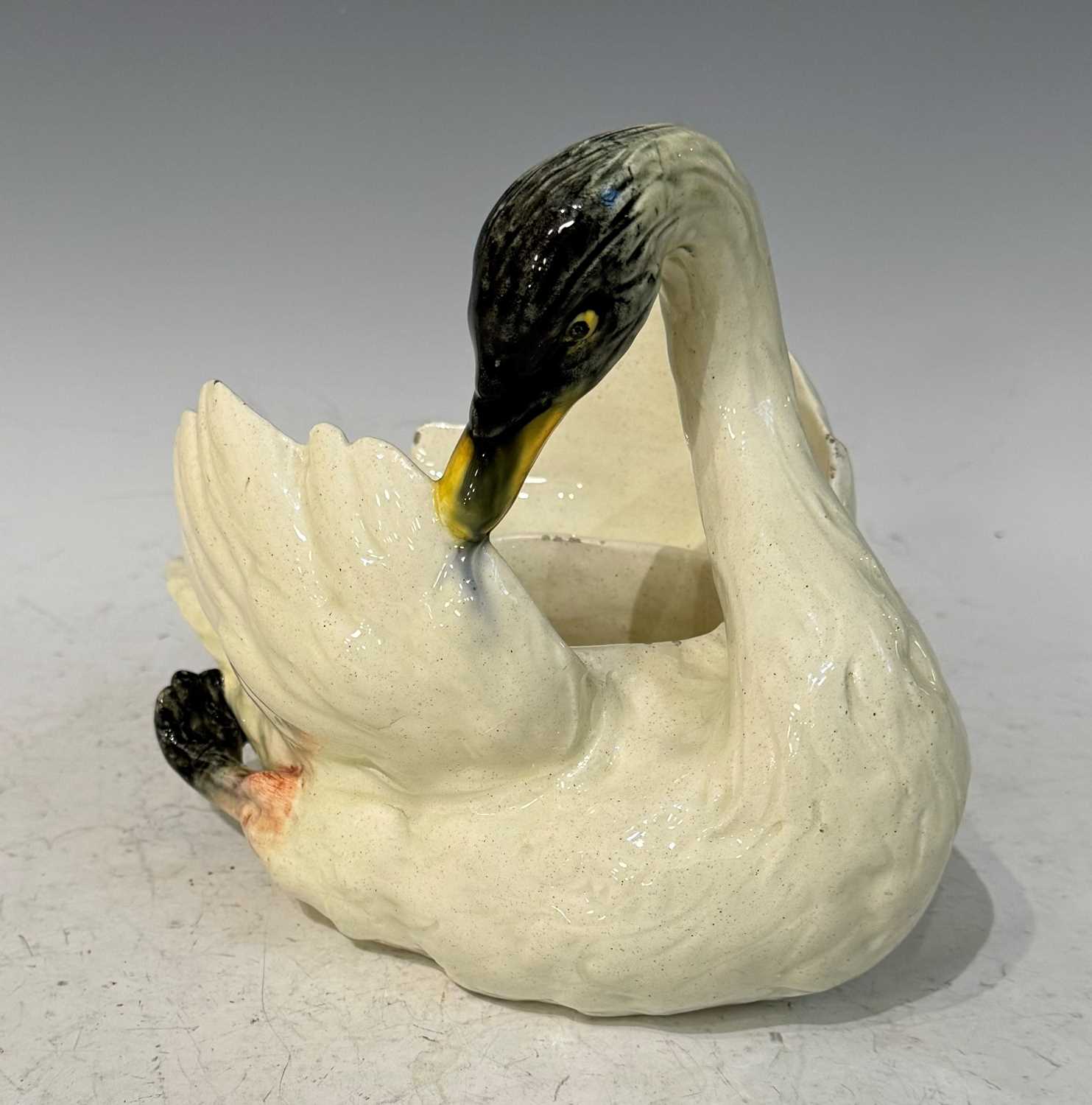 A Vallauris pottery swan by P. Perret, the underside with painted marks / signature, 19cm high.
