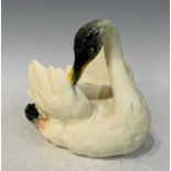 A Vallauris pottery swan by P. Perret, the underside with painted marks / signature, 19cm high.